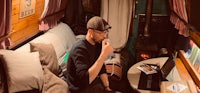 a man sitting on a couch with a laptop in front of him