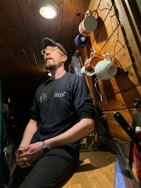 a man sits at a desk in a small room